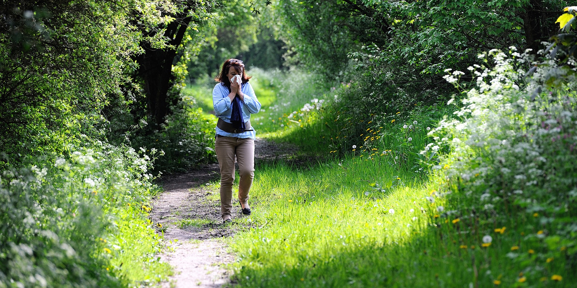 A woman blows her nose in Godewaersvelde, northern France on May 18, 2013, as the return of pleasant weather marks the arrival of allergenic pollen.